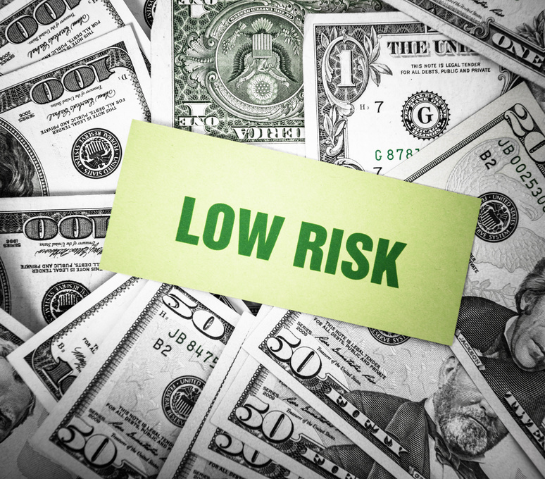 Bunch of dollars with "low risk" greetings card